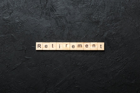 retirement written word on wood block. retirement text on cement table for your design, concept.の写真素材