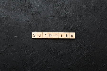 surprise written word on wood block. surprise text on table.