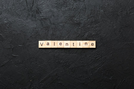 valentine word written on wood block. valentine text on table, concept.の写真素材