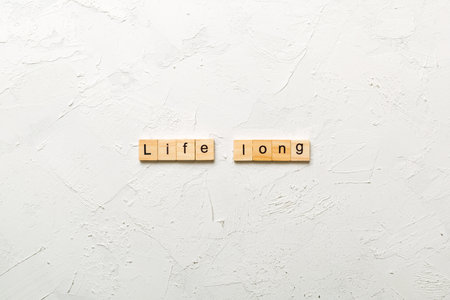 life long word written on wood block. life long text on table, concept.の写真素材