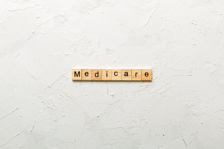 medicare word written on wood block. medicare text on table, concept.の写真素材