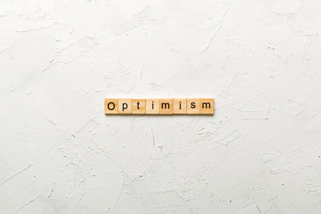 Optimism word written on wood block. Optimism text for your design, concept.の写真素材