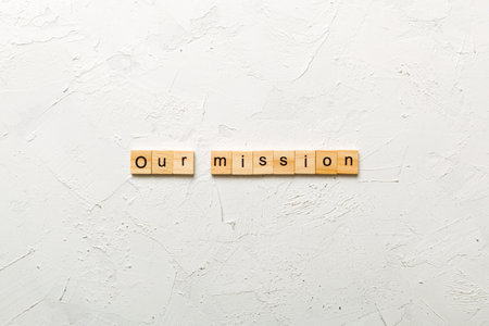 our mission on word written on wood block. our mission text on table, concept.の写真素材