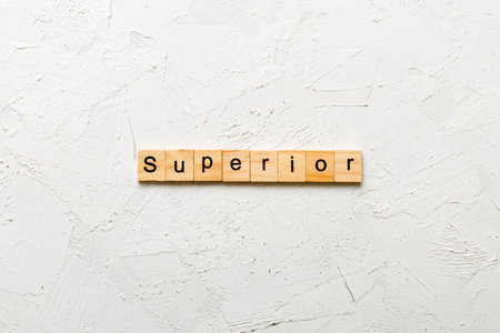 SUPERIOR word written on wood block. SUPERIOR text on cement table for your design, concept.の写真素材