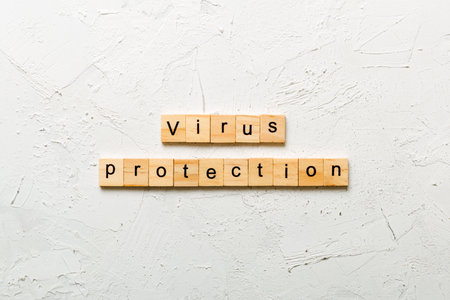 Virus protection word written on wood block. Virus protection text on cement table for your design, concept.の写真素材