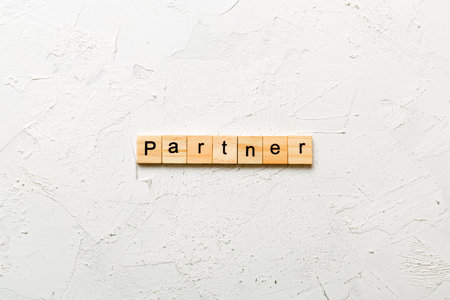 PARTNER word written on wood block. PARTNER text on table, concept.の写真素材
