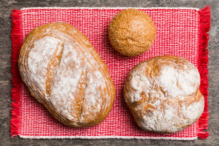 Assortment of freshly baked bread with napkin on rustic table top view. Healthy unleavened bread....