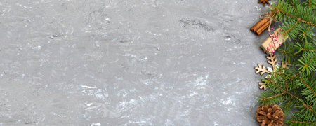 Christmas background with fir tree and gift box on wooden table. Top view with copy space for your design.の写真素材