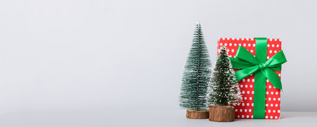 Christmas composition. craft Gift box, small tree, branches and craft DIY decorations on white background. New year concept. Christmas home decoration Flat lay, top view, copy space.の写真素材