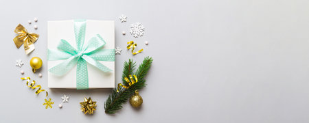 Top view Flat lay Christmas decorations and gift box on colored background with copy space....