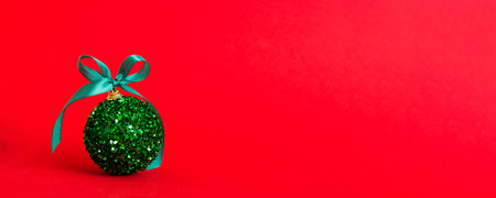 Christmas ball on colored background. decoration bauble with ribbon bow with copy space.の写真素材