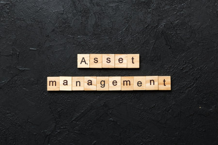 Asset Management word on wood block. Asset Management text on table, concept.の写真素材