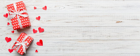 Valentine day composition: red gift box with bow and heart. View from above. Space for text. Holiday greeting card.の写真素材