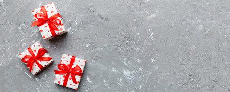 Valentine day composition: red gift box with bow and heart. Christmas present. View from above....