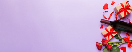 Valentine's day composition with red wine, rose flower and gift box on table. Top view, flat lay. Holiday concept.の写真素材