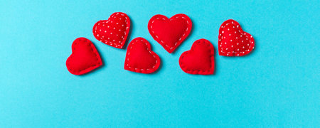 Composition of textile red hearts on colorful background with empty space for your design. Top view of St. Valentine's day concept.の写真素材
