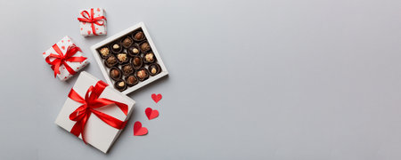 Delicious chocolate pralines in red box for Valentine's Day. Heart shaped box of chocolates top view with copy space.の写真素材