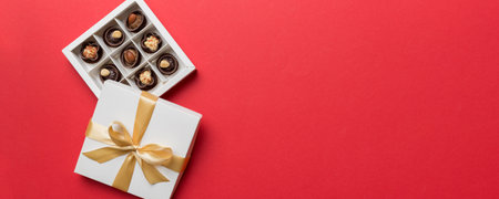 White box with chocolates candies and golden tape. top view with copy space.の写真素材