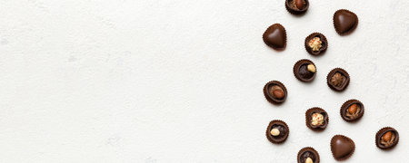 Different kinds of chocolates on colored table close-up. Top View and Flat Lay with copy space.