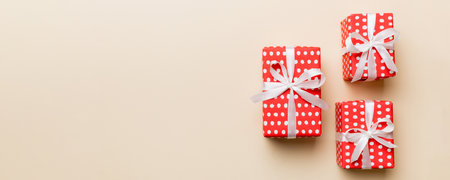 Valentine day composition: red gift box with bow and heart. View from above. Space for text. Holiday...