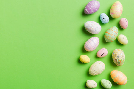 Happy Easter concept. Preparation for holiday. Easter eggs on colored background. flat lay top view...
