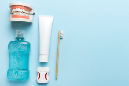 Mouthwash and other oral hygiene products on colored table top view with copy space. Flat lay. Dental hygiene. Oral care kit. Dentist concept.の写真素材