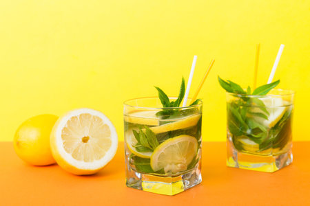 Mojito summer refreshing cocktail with ice and mint. mojito cocktail with lime, lemon and mint in a tall glass with a stick.の写真素材