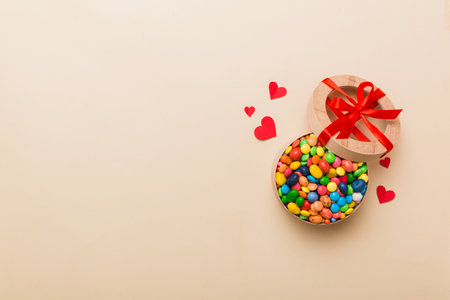 Valentine day composition: sweet candy, with gift boxes with and red felt hearts, photo bow template, background. Top View with copy space.の写真素材