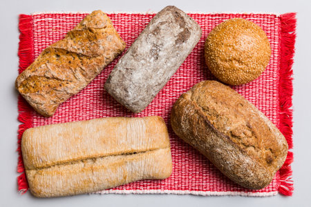 Assortment of freshly baked bread with napkin on rustic table top view. Healthy unleavened bread.の写真素材