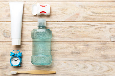 Mouthwash and other oral hygiene products on colored table top view with copy space. Flat lay. Dental hygiene. Oral care products and space for text on light background. conceptの写真素材