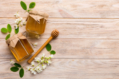honey jar with acacia flowers and leaves. fresh honey top view flat lay.の写真素材