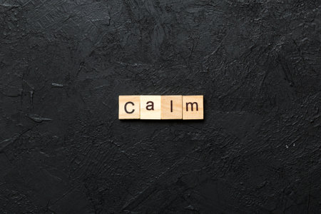 calm written word on wood block. calm text on cement table for your design, concept.の写真素材
