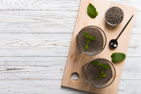 Healthy breakfast or morning with chia seeds lemon and mint on table background, vegetarian food, diet and health concept. Chia pudding with lemon and mint.の写真素材