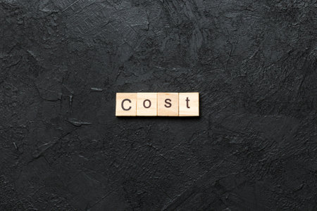 COST word written on wood block. COST text on table, concept.の写真素材