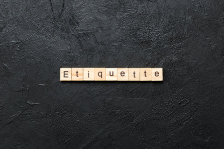 ETIQUETTE word written on wood block. ETIQUETTE text on cement table for your design, concept.の写真素材