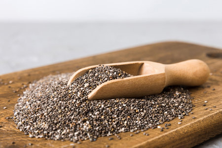 Chia seeds in bowl and spoon on colored background. Chia seeds in small bowl. Healthy superfood.の写真素材