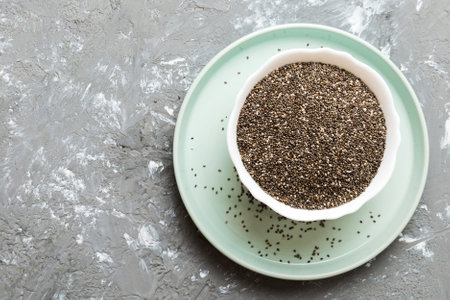 Chia seeds in bowl on colored background. Healthy Salvia hispanica in small bowl. Healthy superfood.の写真素材