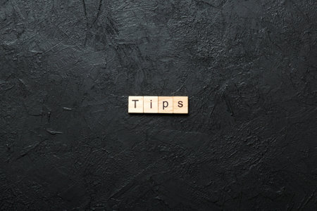 tips written word on wood block. tips text on table, concept.の写真素材