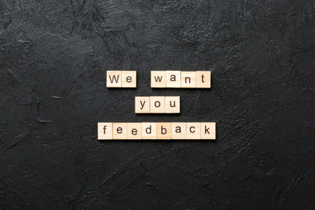 We want your feedback word written on wood block. We want your feedback text on cement table for your design, Top view concept.の写真素材