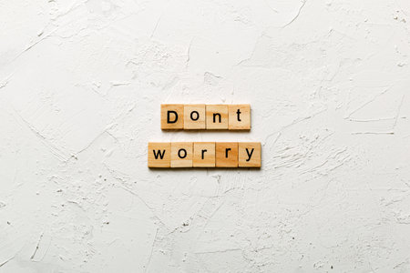Don't worry word written on wood block. Don't worry text on cement table for your design, Top view concept.の写真素材