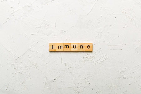 Immune word written on wood block. Immune text for your design, Top view concept.の写真素材
