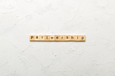 partnership written word on wood block. partnership text on cement table for your design, concept.の写真素材