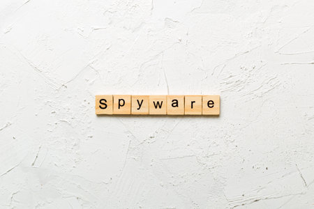 spyware word written on wood block. spyware text on cement table for your design, concept.の写真素材