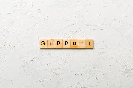 Support written word on wood block. Support text on cement table for your design, concept.の写真素材
