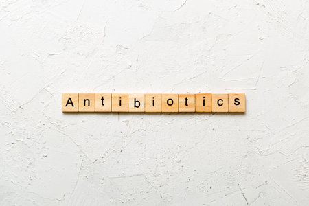 antibiotic written word on wood block. antibiotic text on table, concept.の写真素材