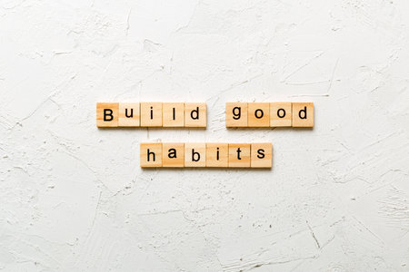 Build good habits word written on wood block. Build good habits text on table, concept.の写真素材