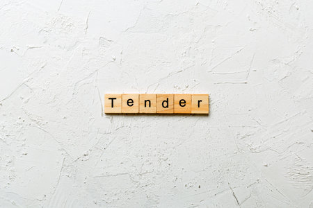 tender written word on wood block. tender text on table, concept.の写真素材