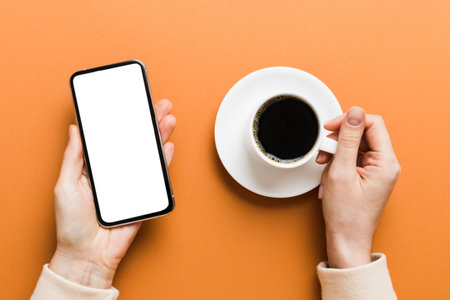 Top view of woman hands holding smart phone with blank copy space screen for your text message or information content. woman hand using phone white screen on top view.の写真素材