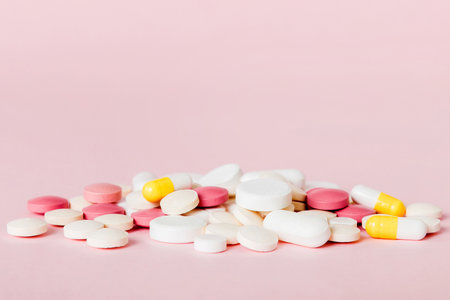 Many different colorful medications and pills perspective view. Set of many pills on colored...