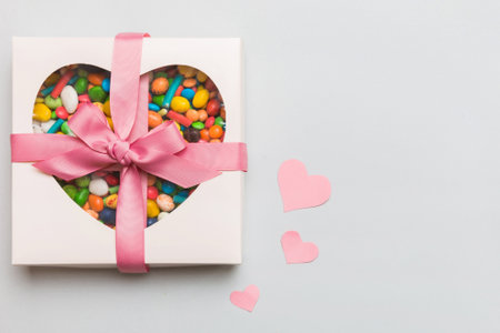 Valentine day composition: sweet candy, with gift boxes and red felt hearts, photo bow template, background. Top View with copy space.の写真素材